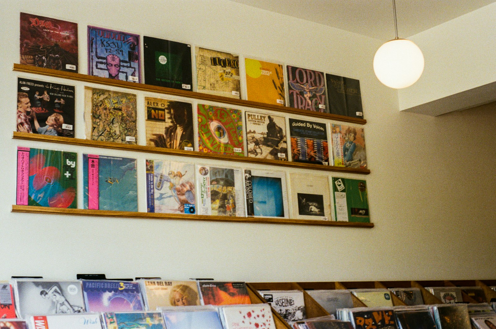 Vinyl records are displayed on shelves of a shop.